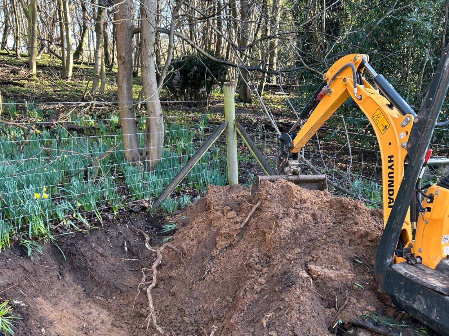 Digger gathering soil and roots